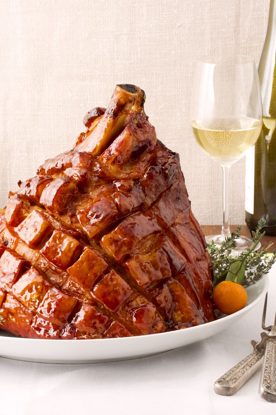 sweet and sticky apricot glazed ham on a white plate