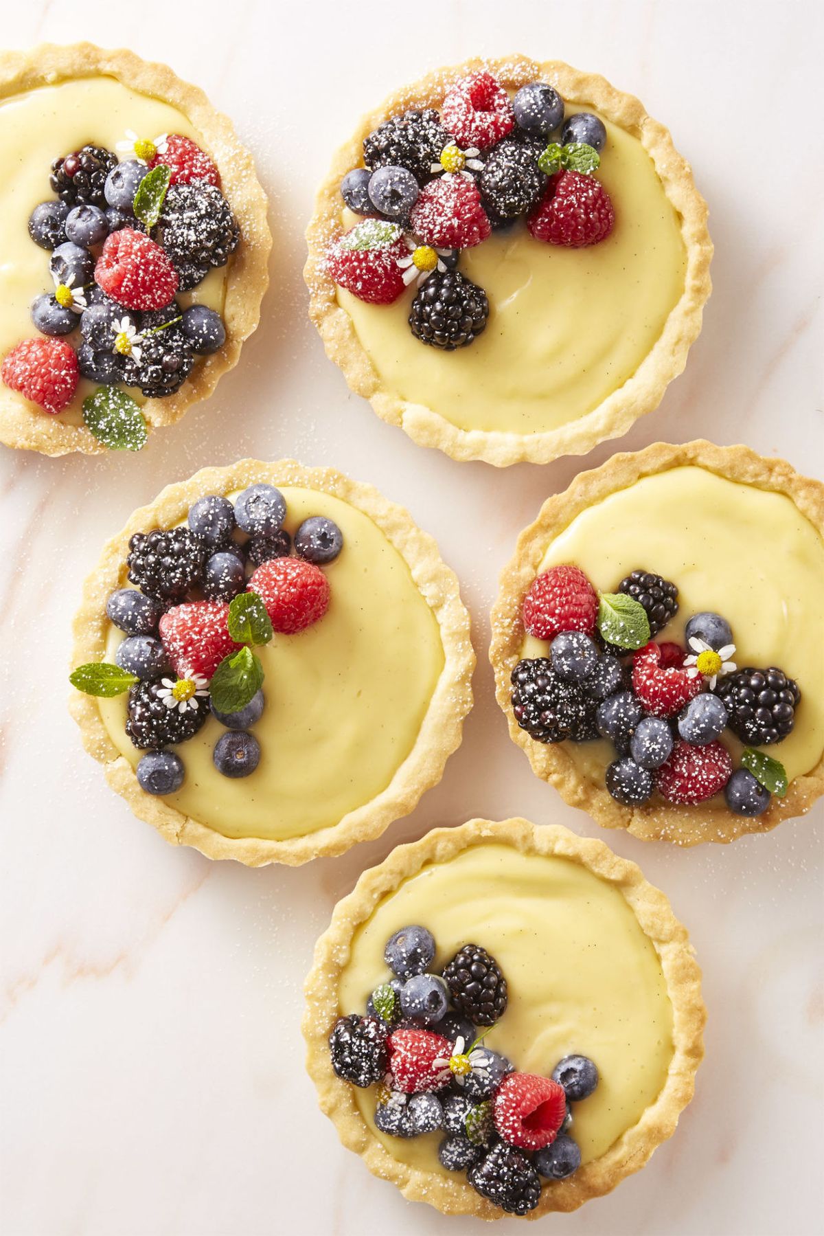 cream tartlets with fresh berries on top