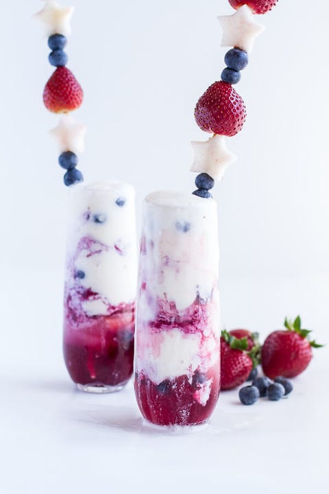 berry margarita floats with fresh strawberries and blueberries