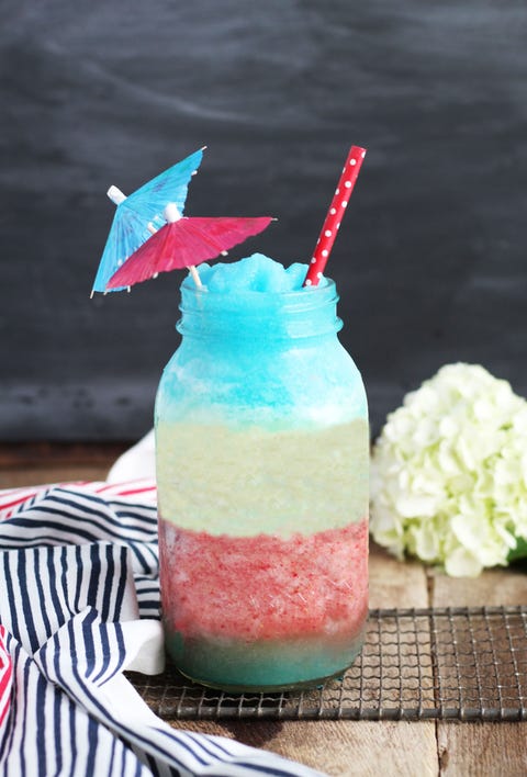 a red white and blue pina colada in a large mason jar and umbrella on top
