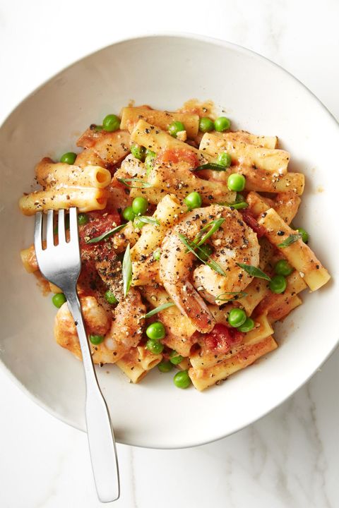 shrimp ziti with shrimp and peas on a white plate