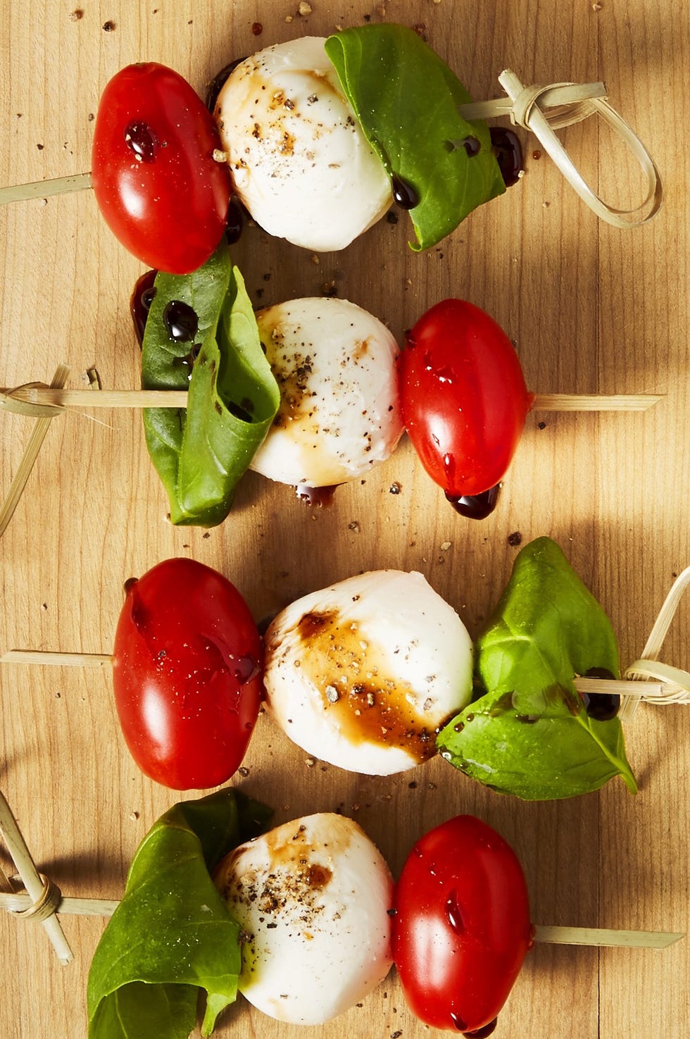 caprese bites with basil, tomato, and mozzarella served on a stick