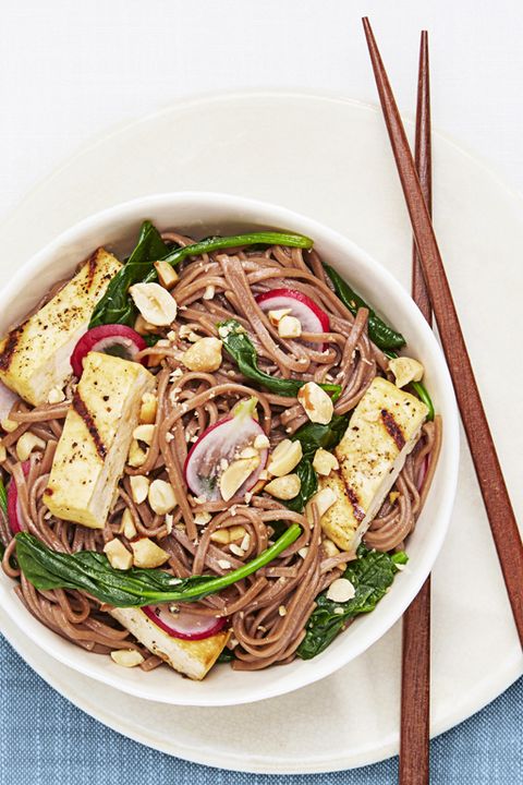 soba salad with grilled tofu in a bowl and chopsticks on the side