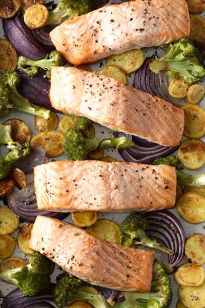 roasted salmon on a sheet pan with red onion, broccoli and potatoes