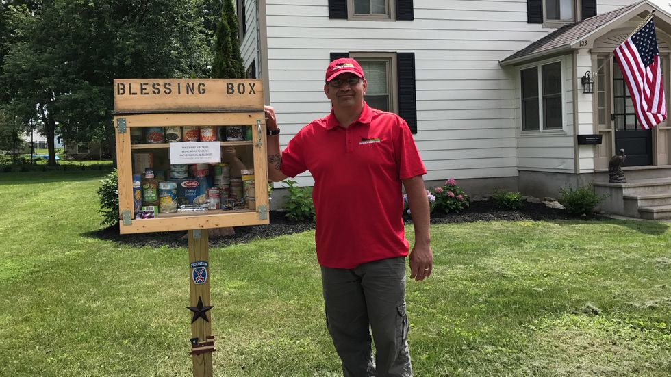Man builds mini food pantry on front lawn.