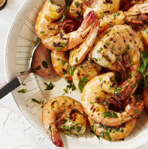 old bay shrimp with fresh herbs in a white bowl