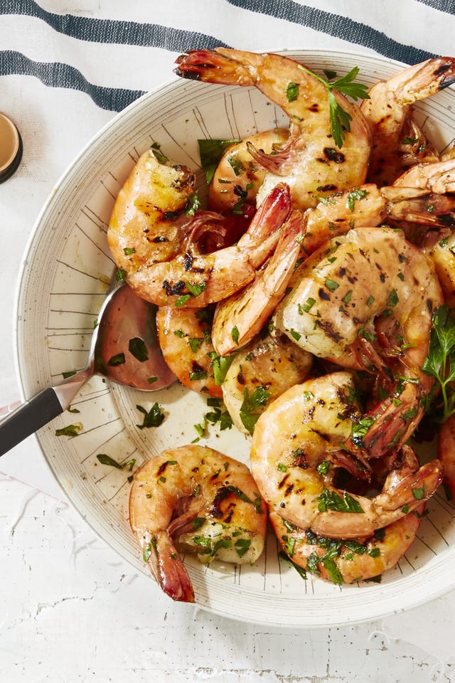 old bay shrimp with fresh herbs in a white bowl
