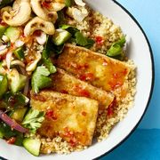 crispy tofu bowl with couscous and roasted cashews