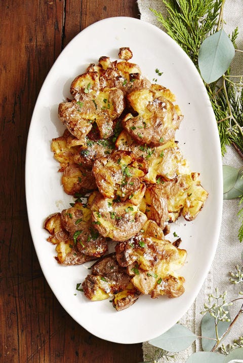 smashed potatoes on a white plate