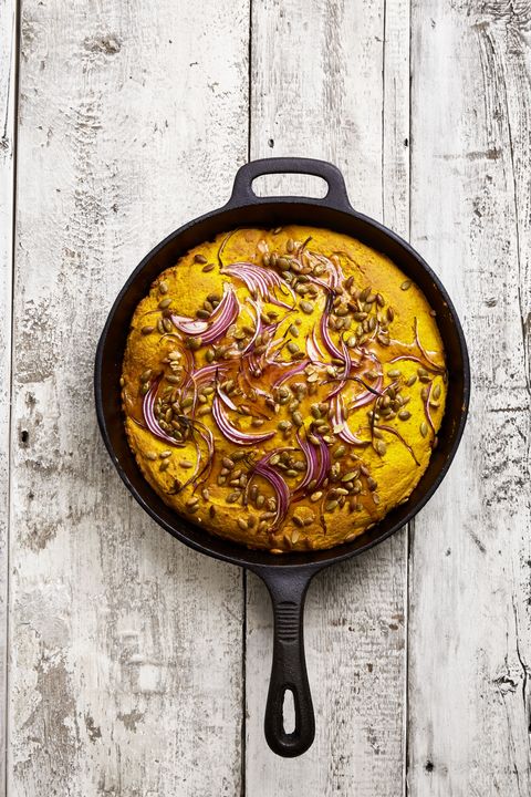 baked cornbread with red onion in a cast iron skillet