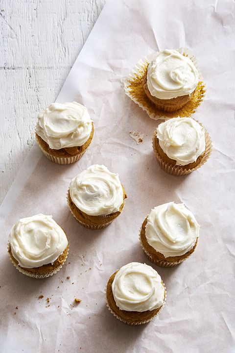 pumpkin spice cupcakes with white frosting on top