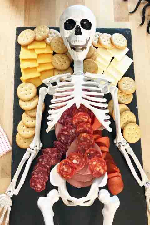 halloween party ideas, char boo terie with skeleton body with cheese, crakers and meat inside