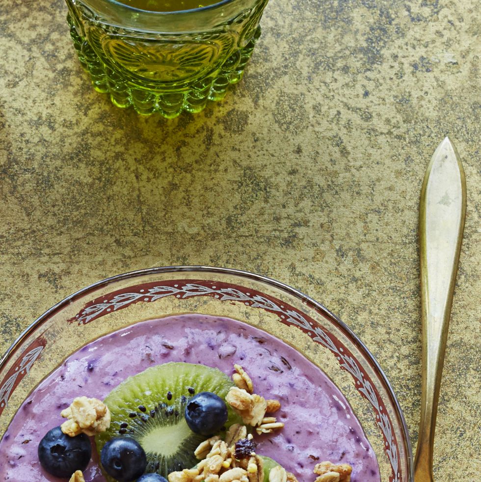 fruity yogurt parfait with kiwi and blueberries in a glass bowl