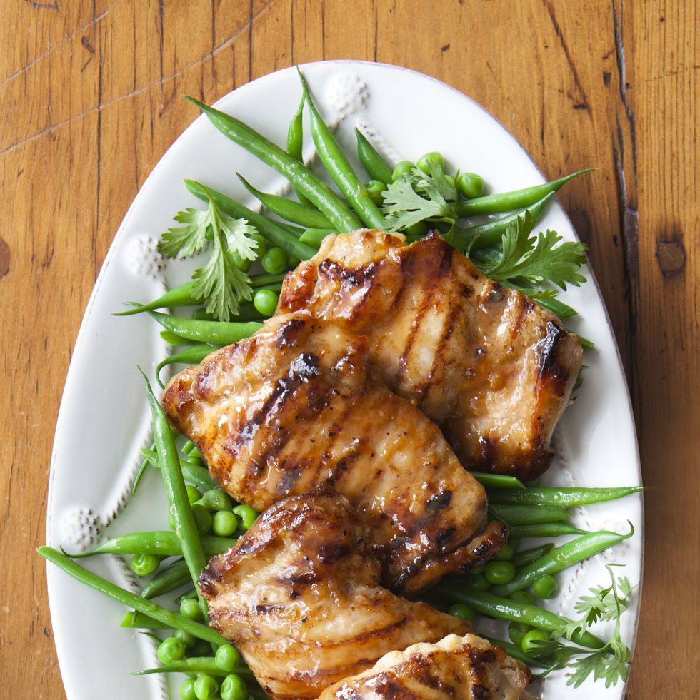 maple glazed chicken with green beans on a white platter