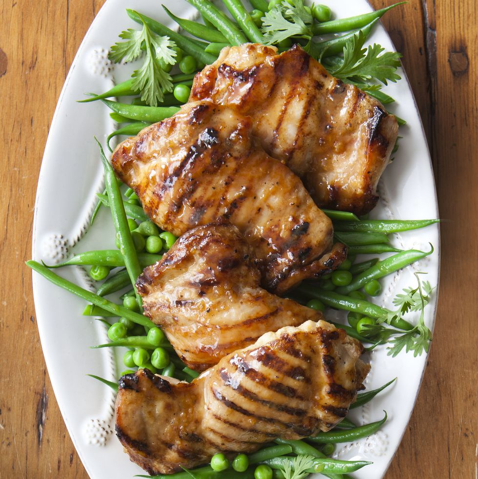 maple glazed chicken with green beans on a white platter