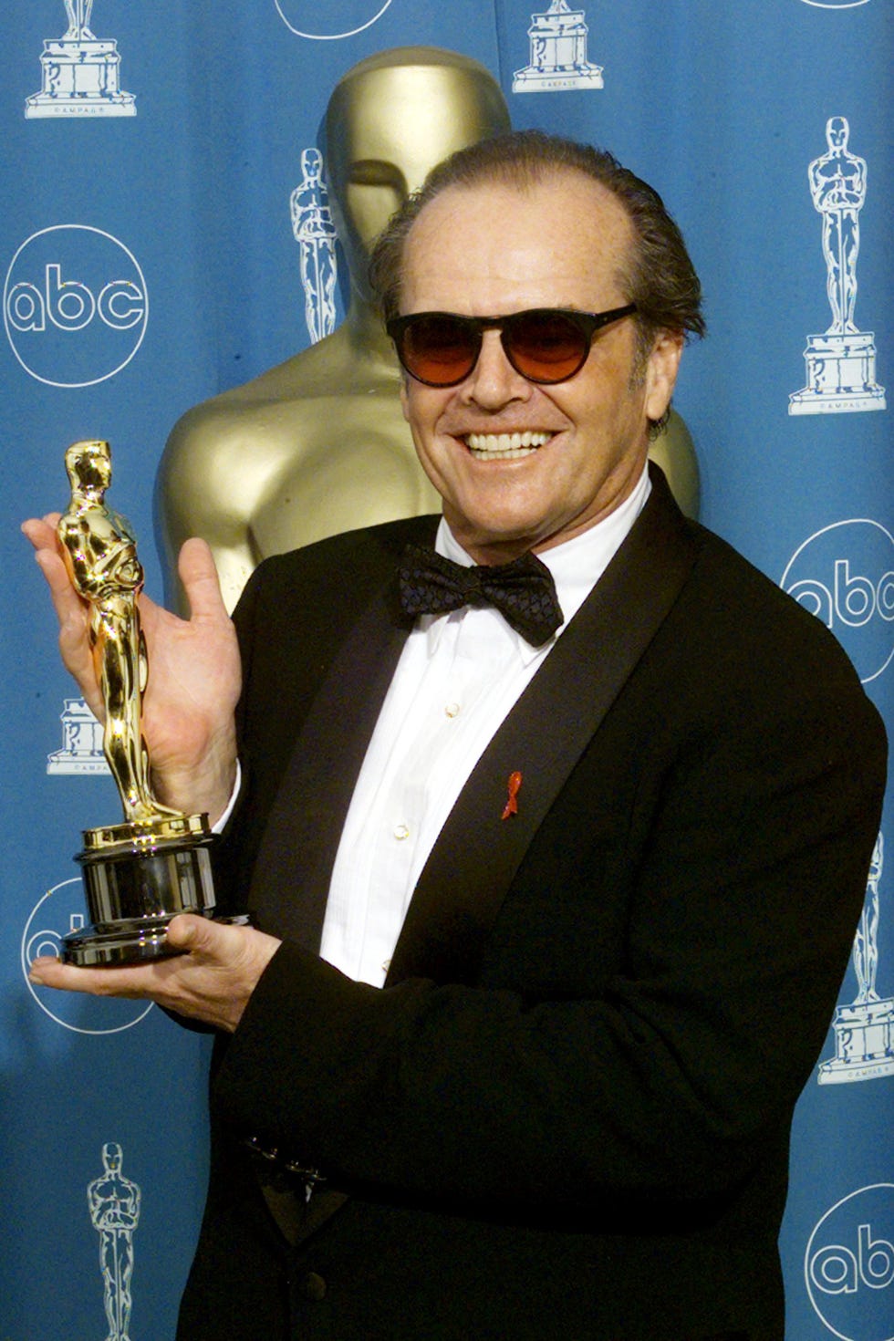 award, eyewear, tuxedo, formal wear, trophy, suit, saxophonist, brass instrument,