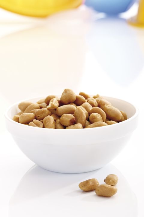 cashews in a white bowl on a white background