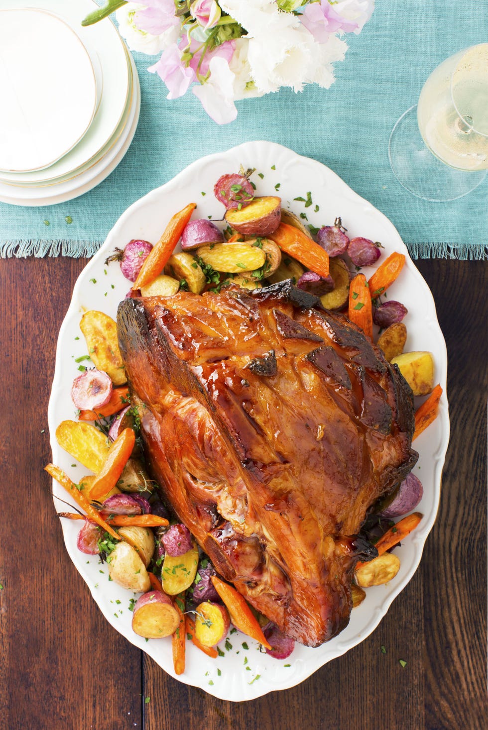 apricot mustard ham with roasted vegetables on a white platter