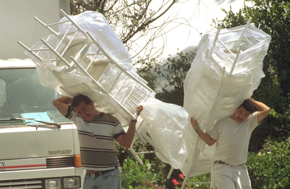 Workers bring in chairs for Streisand and Brolin's wedding in 1998.