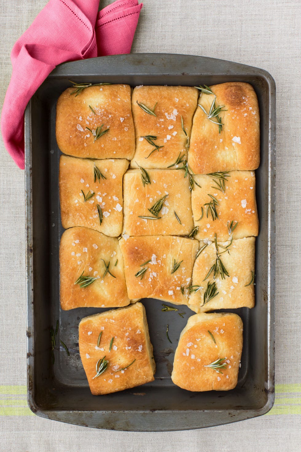 a baking dish of buttery rosemary rolls