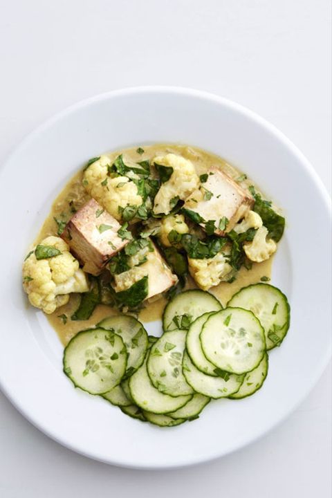 green curry tofu with a cucumber salad on the side