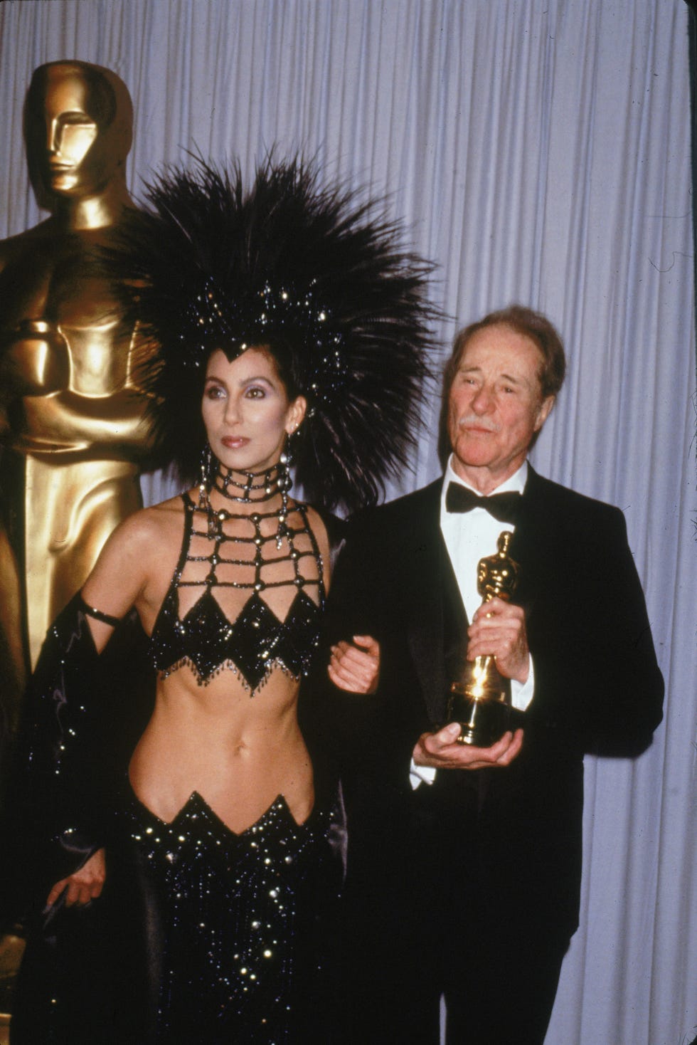 most scandalous oscars moments - cher's feathered outfit, 1986