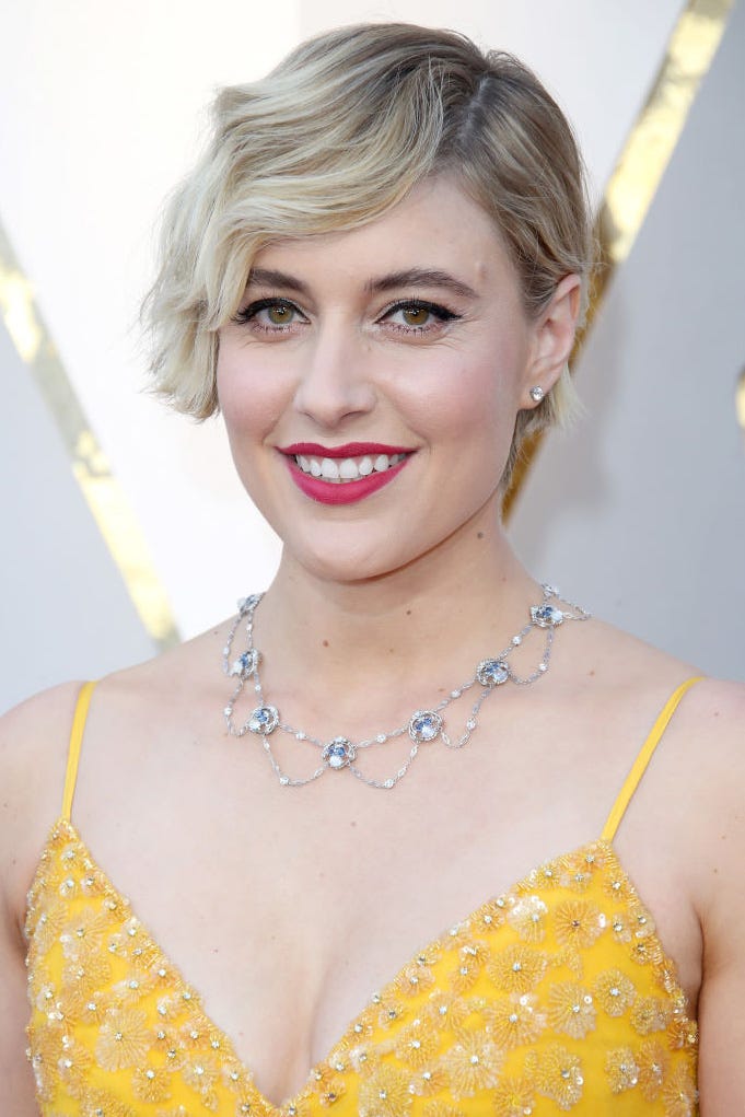 greta gerwig wears a short wavy pixie cut, one of the best wedding guest hairstyles