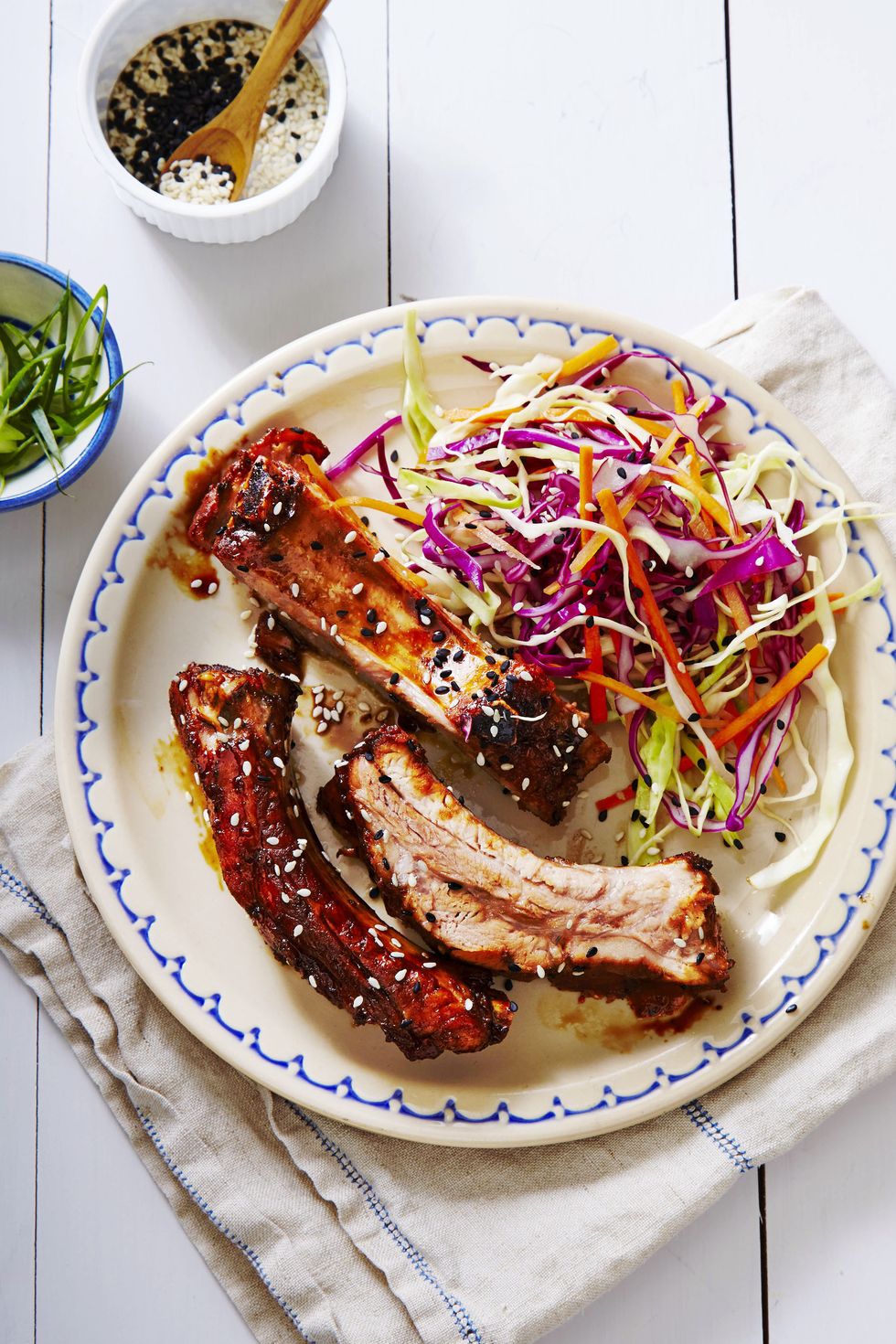 teriyaki ribs with shredded cabbage on a white plate