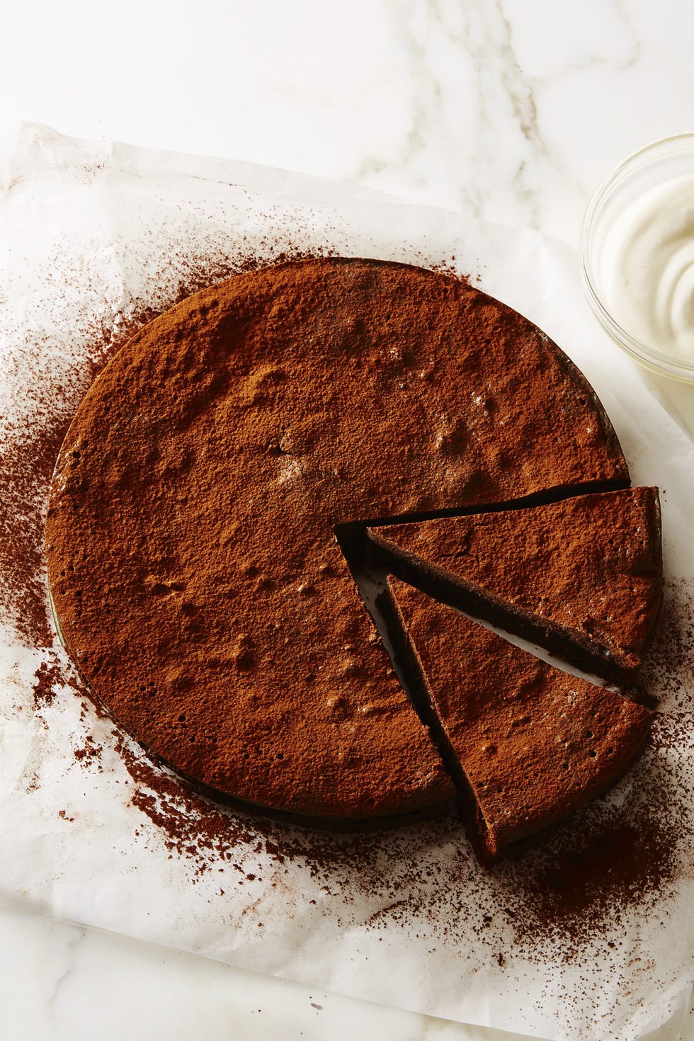 a chocolate flourless fudge cake with cocoa powder sprinkled on top