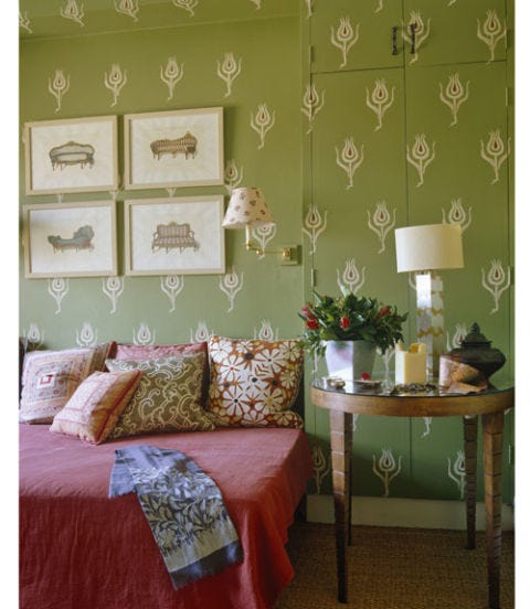 bedroom with green wall paper and fun and colorful bedding