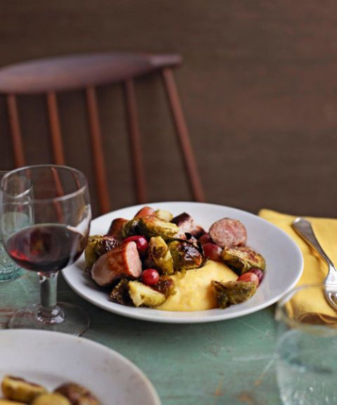 brussels sprouts with sausage and grapes on creamy polenta