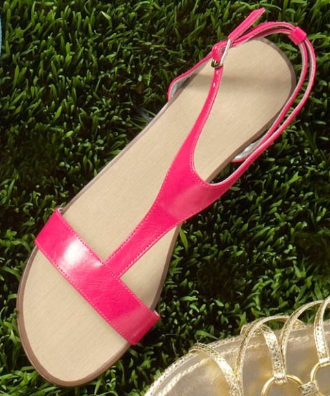 pink t-strap sandals on green grass