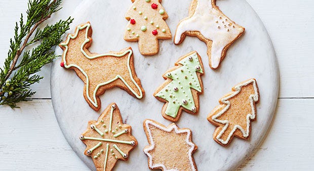 christma cutout cookies in the shape of christmas trees and reindeers