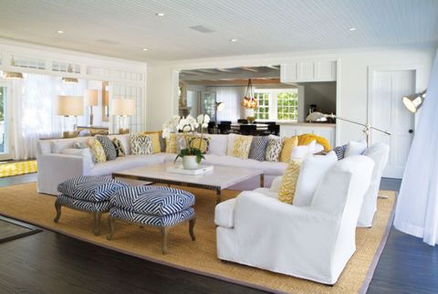 living room with white couch and yellow accents