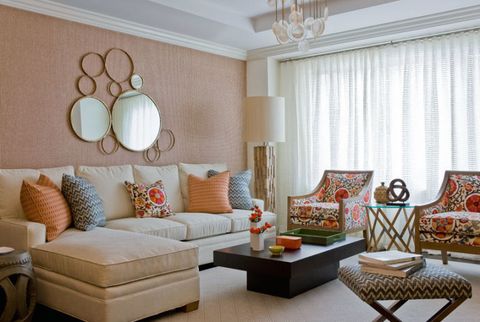 classy living room with patterned armchairs and mirror