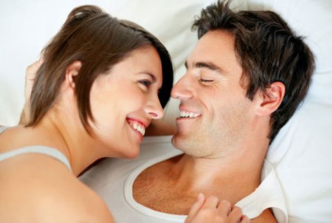 couple laughing in bed