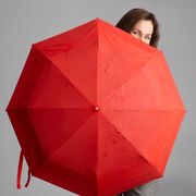 woman standing behind umbrella