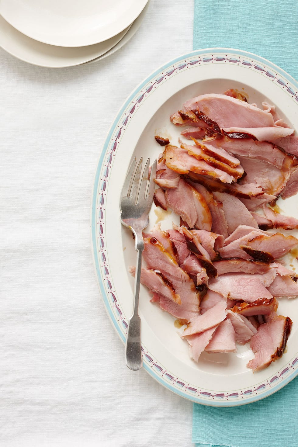 shredded root beer glazed ham  served on a white plate