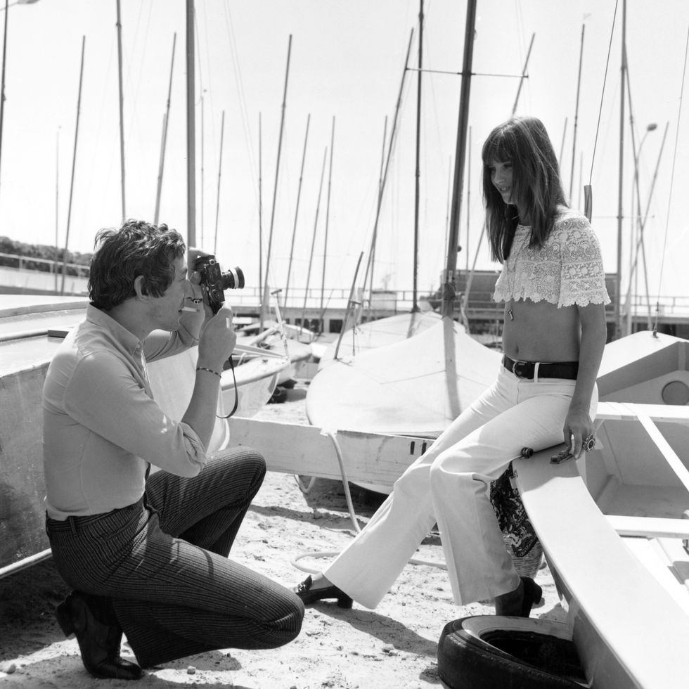 French singer, actor and director Serge Gainsbourg (1928 - 1991) photographs English actress Jane Birkin at the Cannes Film Festival, 19th May 1969. (Photo by Archive Photos/Getty Images)