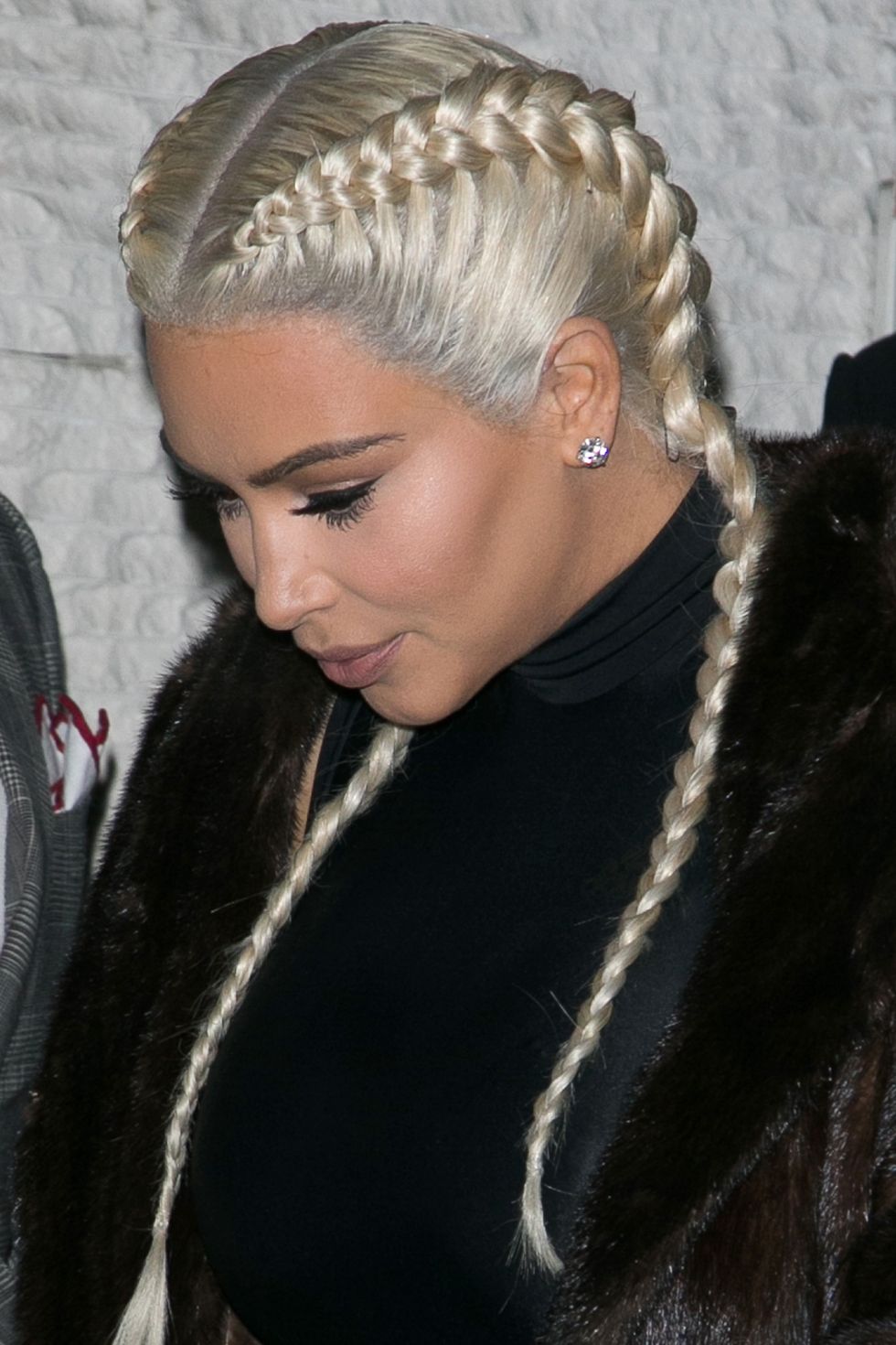 <p>Kim does a hair hue 180 with a pair of platinum plaits.</p>