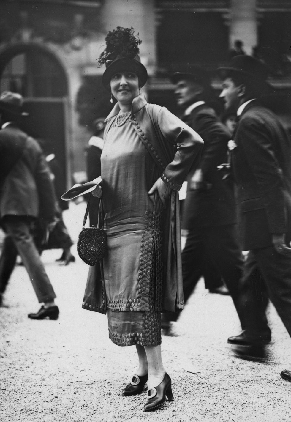 1924:  Dress with long  tunic effect bodice over a straight matching underskirt and three-quarter coat to match. High crowned hat, pochette handbag and high heels complete the outfit. Designed by Jenny.  (Photo by Seeberger Freres/General Photographic Agency/Getty Images)