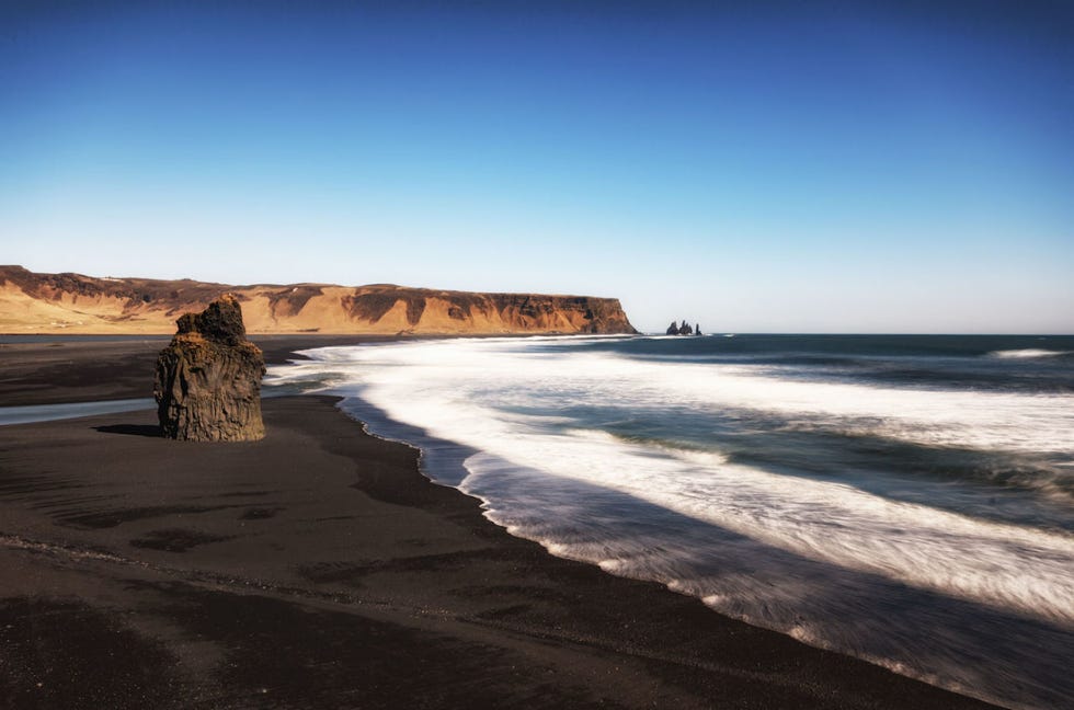 <p>Bucolico e drammatico il mondo attorno a <strong>Vik</strong>: cammino sulla spiaggia nera, di fronte alle scogliere basaltiche regno dei pulcinella di mare. I cupi faraglioni in mezzo al mare,  puntati verso il cielo come artigli, secondo una leggenda sarebbero troll pietrificati e porta per entrare nel regno degli invisibili.</p>