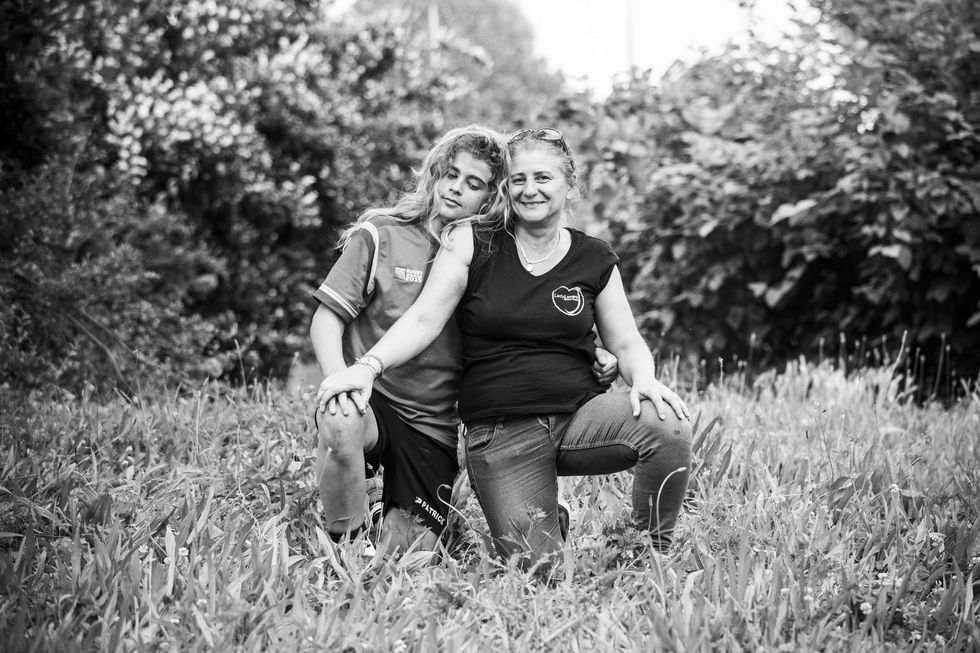 Photograph, Mammal, Happy, People in nature, Interaction, Monochrome photography, Sitting, Monochrome, Sleeveless shirt, Black-and-white, 