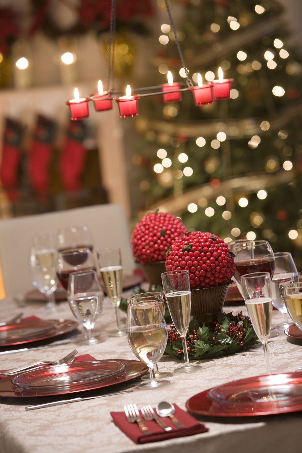 <p>Berry topiairies and miniature red candles set the holiday mood.</p>