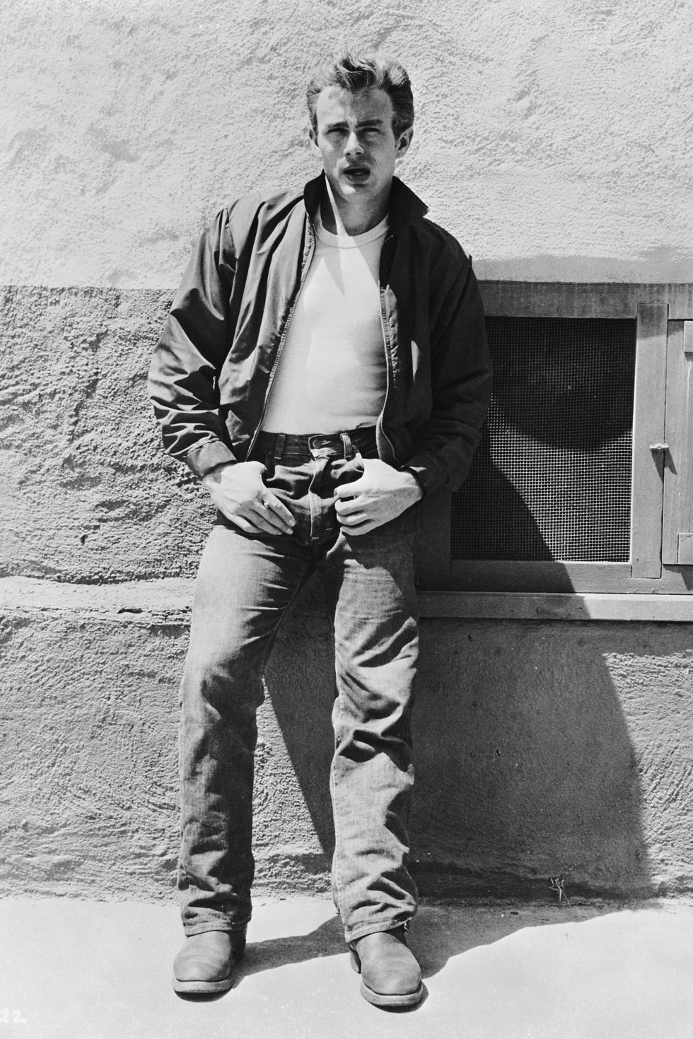 American actor James Dean (1931 - 1955) leans against a wall on the set of director Nicholas Ray's classic film, 'Rebel Without a Cause', 1955. (Photo via John Kobal Foundation/Hulton Archive/Getty Images)