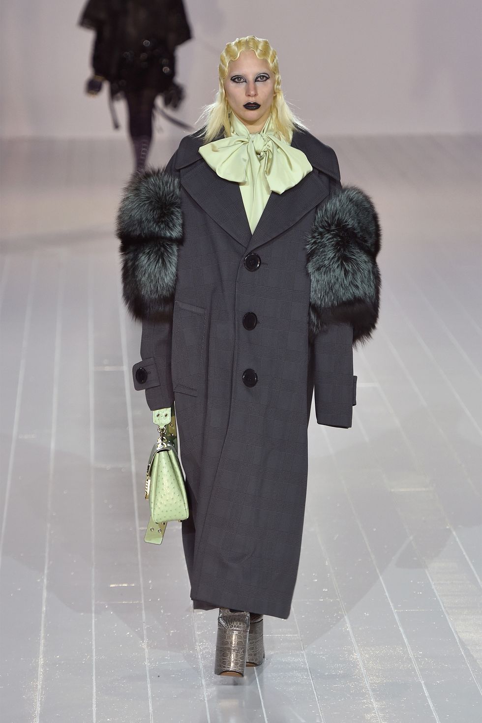 <p>Hidden amongst the lineup of Marc Jacobs' Fall 2016 show was none other than Lady Gaga—who walked the runway in an oversized coat and towering platform heels. Like all the other models in the show, the singer had her hair bleached for the occasion. Gaga's appearance marked NYFW's biggest star-studded runway cameo of the season.</p>