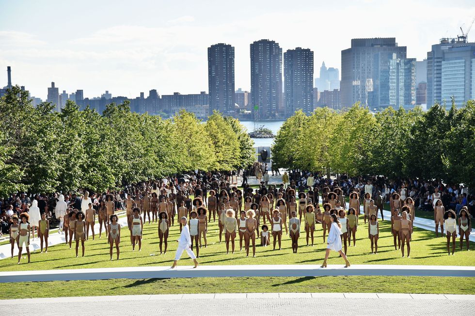 <p>Kanye West created quite the spectacle at New York Fashion Week–but not exactly in the best way. The rapper/designer boarded industry insiders on an hour-long bus ride to an unknown show location—which turned out to be Smallpox Hospital on Roosevelt Island. Much like his past shows, models stood in tactical formation wearing spandex-like looks—this season, however, they stood on a field with the Manhattan skyline in the background. Teyana Taylor, Chanel Iman, Sofia Richie, Amina Blue and more walked the show which ended up being an hours-long project resulting in a few models fainting on the field due to heat and dehydration. It certainly got people talking, though...</p>