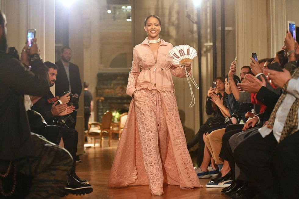 <p>As if Rihanna's Fenty Puma creepers and furry slides didn't dominate 2016 themselves, the singer/designer also headed to Paris to stage her second Puma collection. Making her Paris Fashion Week debut, she unveiled a collection inspired by "Marie Antoinette if she went to the gym" as only Bad Gal Riri could do. For her runway bow, she wore a pink lace suit, pearl choker and Puma fan—reminding us all of her style icon status. </p>