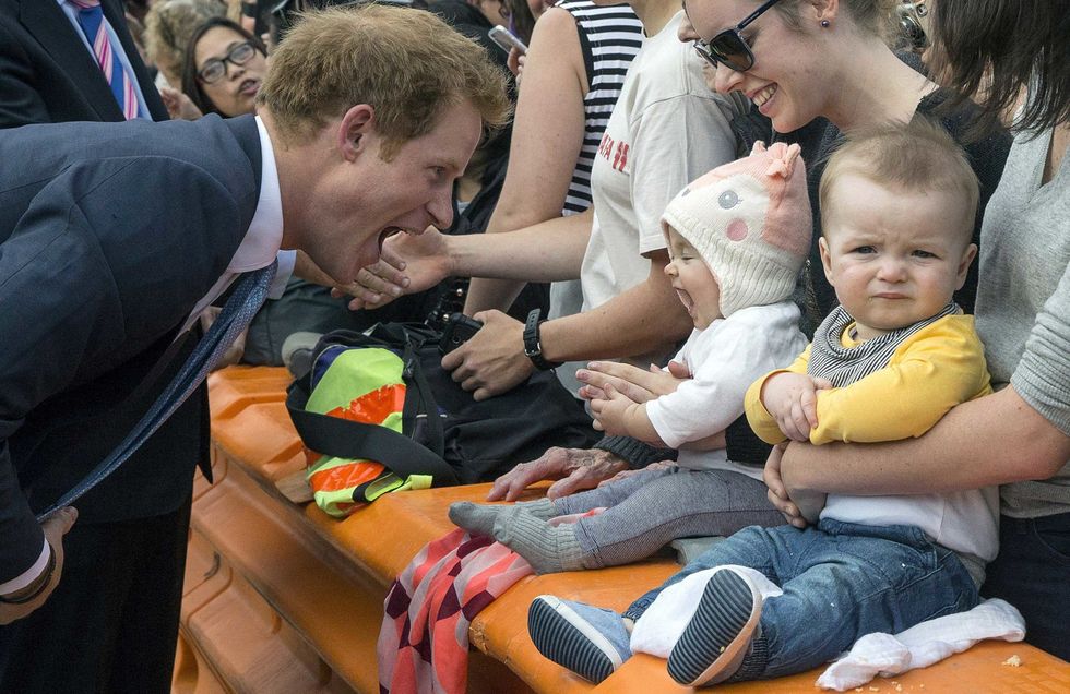 <p>I don't know what's cuter, Prince Harry and his tiny fan or the look on the face of the little guy to the right.</p>