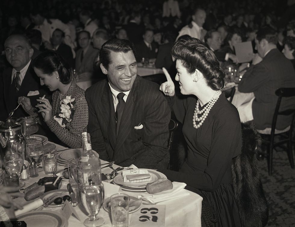 <p>Best Actor nominee Cary Grant (<i data-redactor-tag="i">Penny Serenade</i>) is teased by dinner companion Rosalind Russell during the ceremony at the Biltmore Hotel. Because of the war, the award ceremonies through 1945 were more austere and less formal than in previous years.<span class="redactor-invisible-space" data-verified="redactor" data-redactor-tag="span" data-redactor-class="redactor-invisible-space"></span></p>